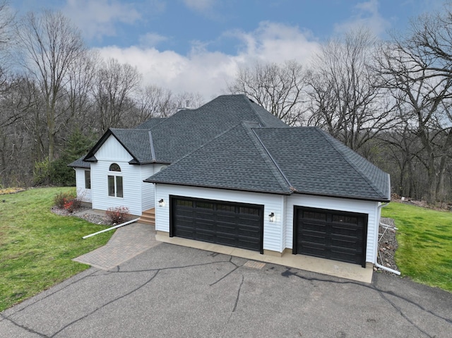 view of front of home featuring a garage and a front lawn