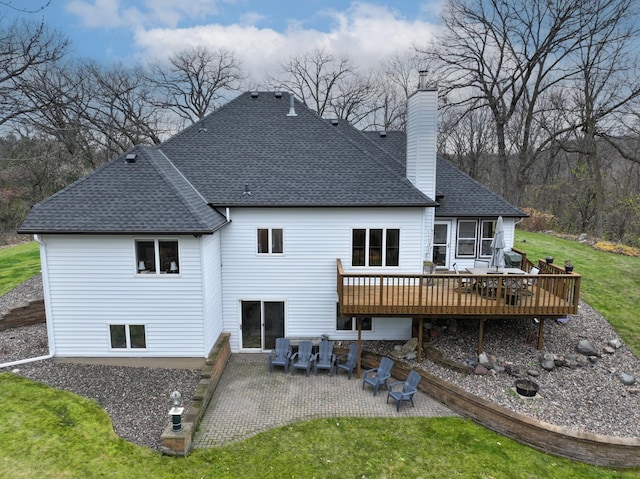 back of house featuring a yard, a patio, and a wooden deck