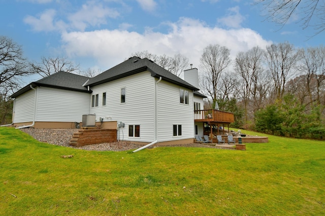 rear view of property featuring a patio area, a yard, and a deck