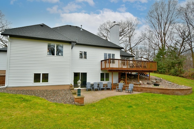 rear view of property featuring a patio area, a yard, and a deck