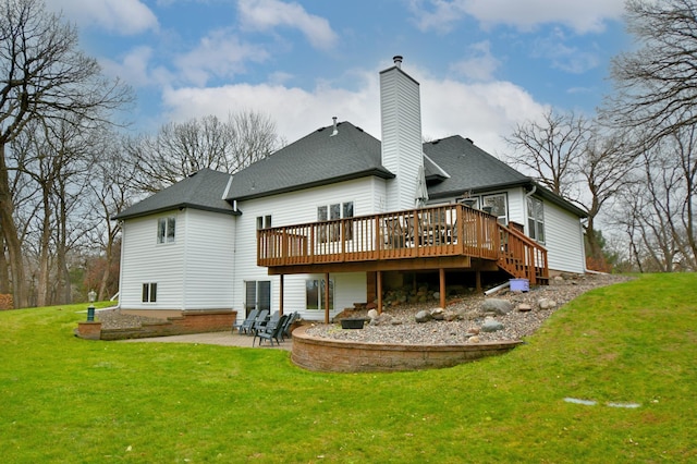 rear view of property featuring a lawn, a patio area, and a deck