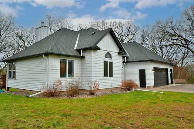 view of side of home featuring a garage and a lawn