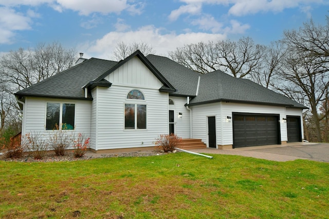 view of front of property with a front yard and a garage