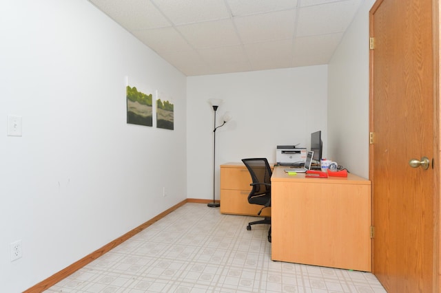 office area with a paneled ceiling