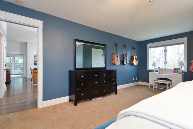 bedroom with carpet floors and a textured ceiling