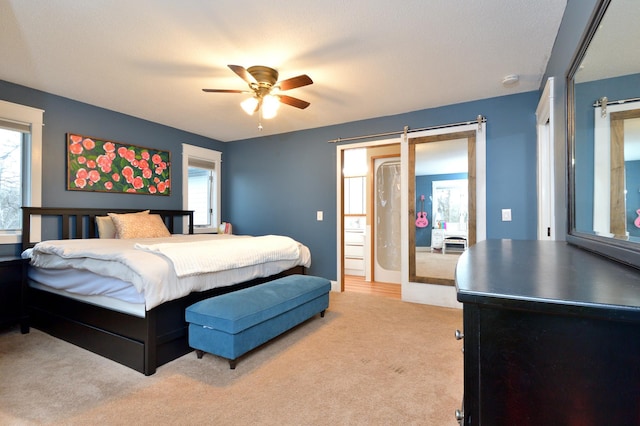 carpeted bedroom with ceiling fan, a textured ceiling, and multiple windows