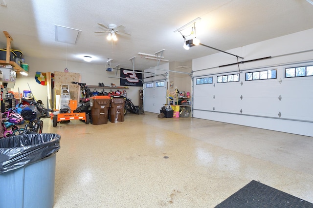 garage featuring ceiling fan and a garage door opener