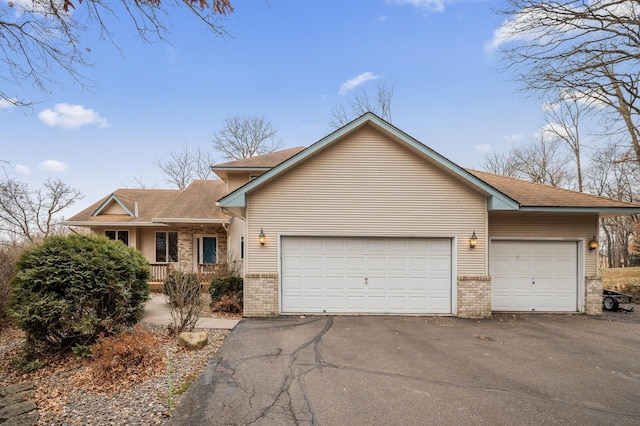 ranch-style house with a porch and a garage