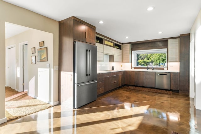 kitchen featuring finished concrete floors, appliances with stainless steel finishes, modern cabinets, and light countertops