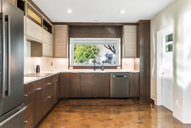 kitchen with light countertops, modern cabinets, and stainless steel appliances