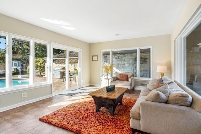 tiled living room with baseboards and a fireplace