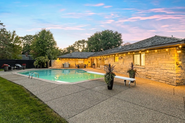 view of pool with a diving board, a fenced in pool, a patio, and fence