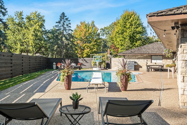 view of swimming pool with a patio area, a fenced in pool, and a fenced backyard