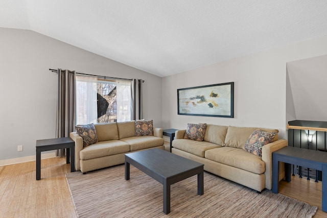 living room with lofted ceiling and light wood-type flooring