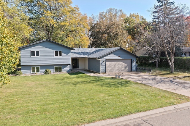 split level home featuring a garage and a front lawn