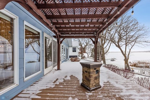 snow covered patio with a pergola