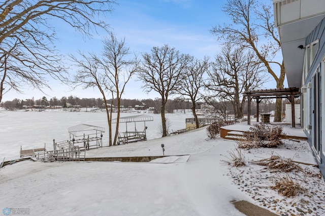 yard layered in snow with a pergola