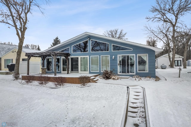 view of snow covered back of property