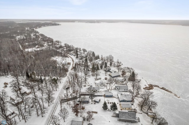 snowy aerial view with a water view