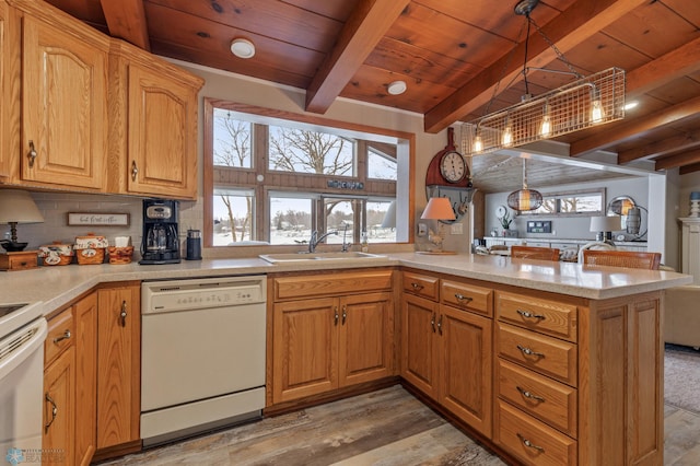 kitchen with kitchen peninsula, light wood-type flooring, white appliances, beamed ceiling, and hanging light fixtures