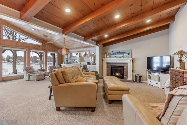 living room featuring vaulted ceiling with beams, light colored carpet, a stone fireplace, and wooden ceiling