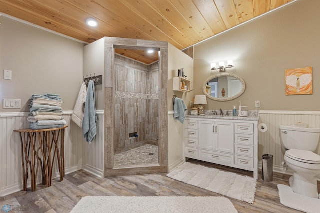 bathroom featuring wooden ceiling, wooden walls, vanity, and wood-type flooring