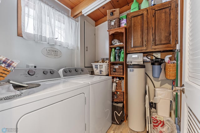 clothes washing area featuring cabinets, light hardwood / wood-style floors, washing machine and dryer, and wood ceiling