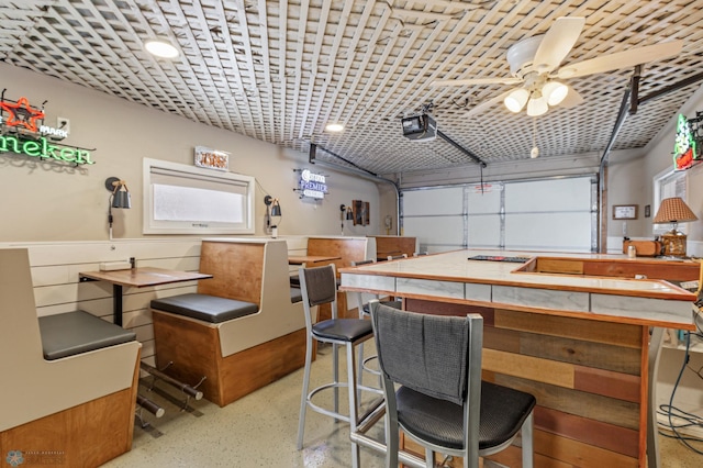 garage with ceiling fan and a garage door opener