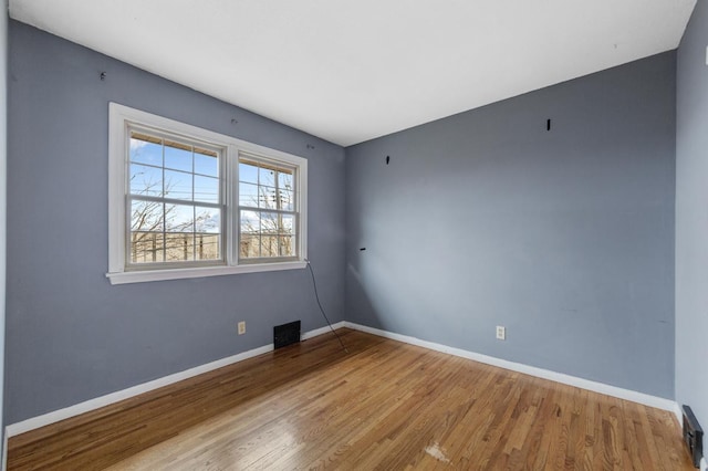 unfurnished room with light wood-type flooring