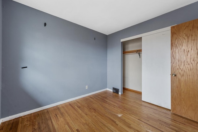 unfurnished bedroom featuring a closet and light hardwood / wood-style flooring