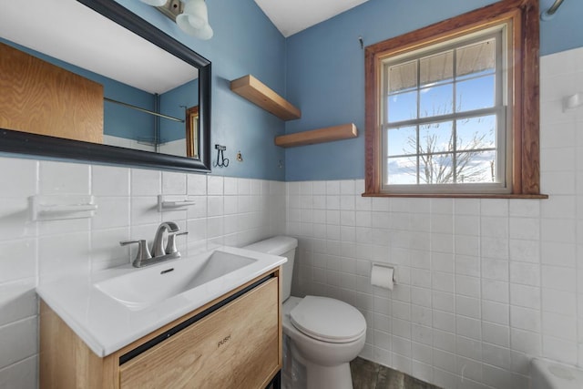 bathroom featuring vanity, wood-type flooring, tile walls, and toilet