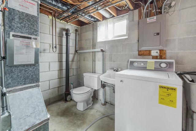 bathroom featuring washer / dryer, concrete floors, electric panel, and heating unit