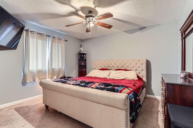 carpeted bedroom with a textured ceiling and ceiling fan