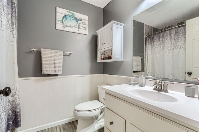 bathroom featuring a shower with curtain, vanity, toilet, and wood-type flooring