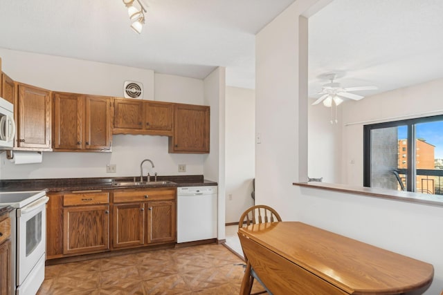 kitchen featuring sink, white appliances, rail lighting, and ceiling fan