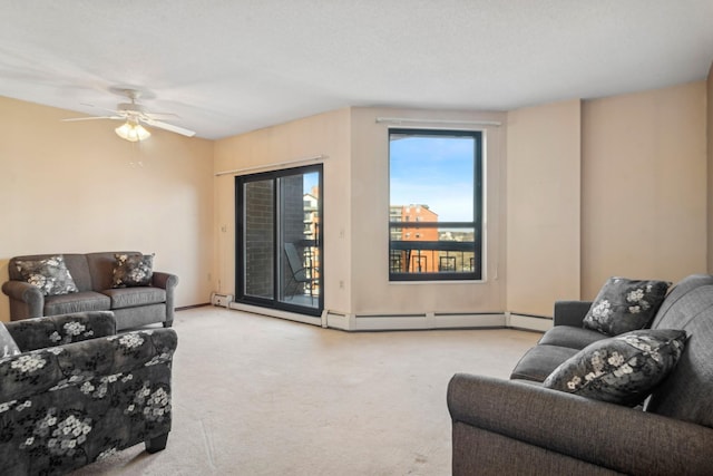 carpeted living room with a baseboard heating unit and ceiling fan