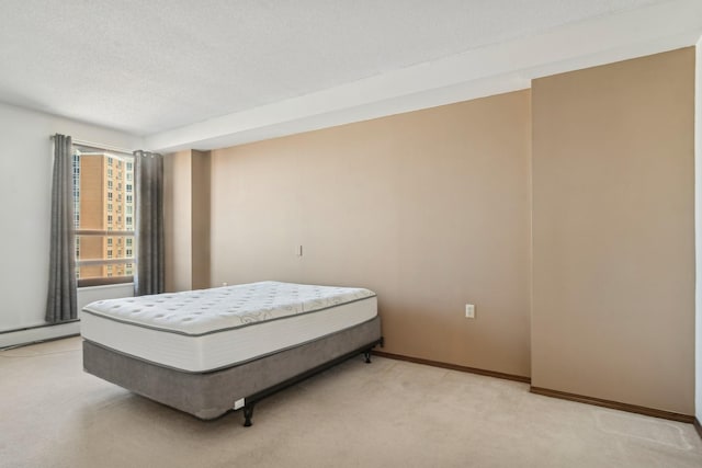 bedroom with light colored carpet and a textured ceiling