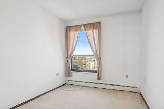 carpeted spare room with baseboard heating