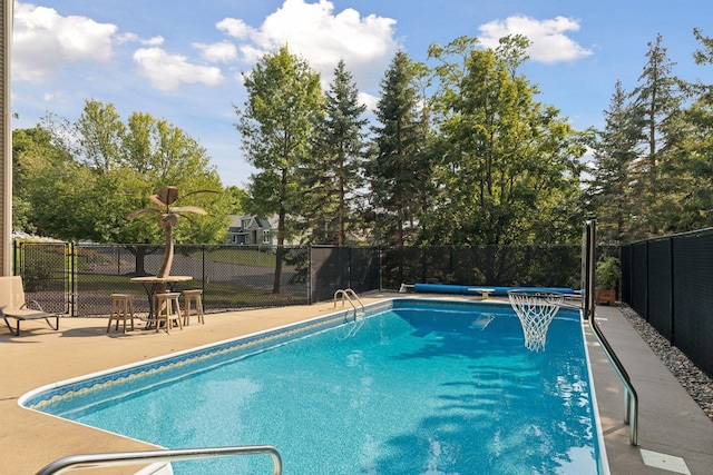 view of pool with a fenced in pool, a patio, and fence