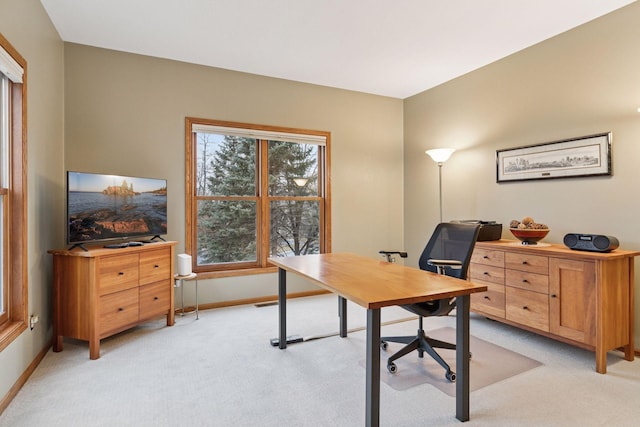 home office featuring baseboards and light colored carpet