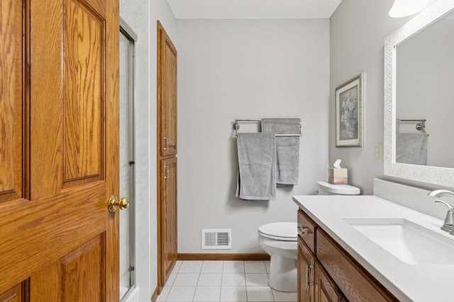 bathroom featuring vanity, visible vents, walk in shower, tile patterned floors, and toilet