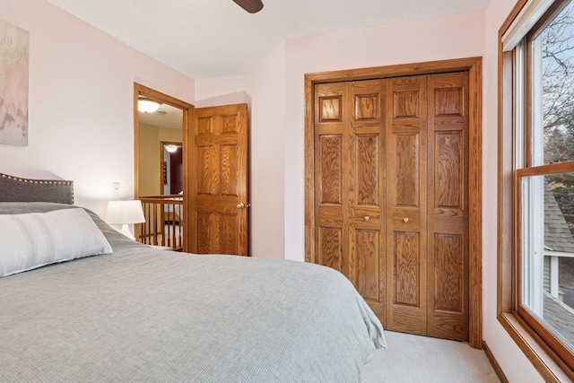 bedroom featuring a closet, a ceiling fan, and carpet flooring