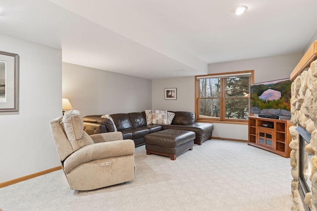 living area featuring baseboards and light colored carpet