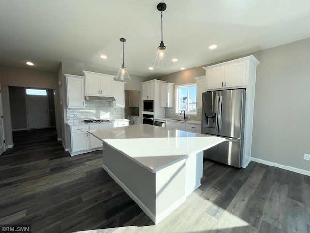 kitchen featuring white cabinets, appliances with stainless steel finishes, dark hardwood / wood-style flooring, and sink