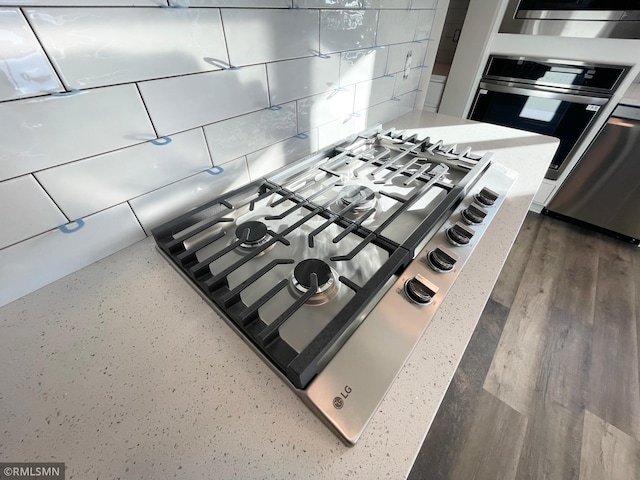 room details featuring dark hardwood / wood-style floors and stainless steel gas cooktop