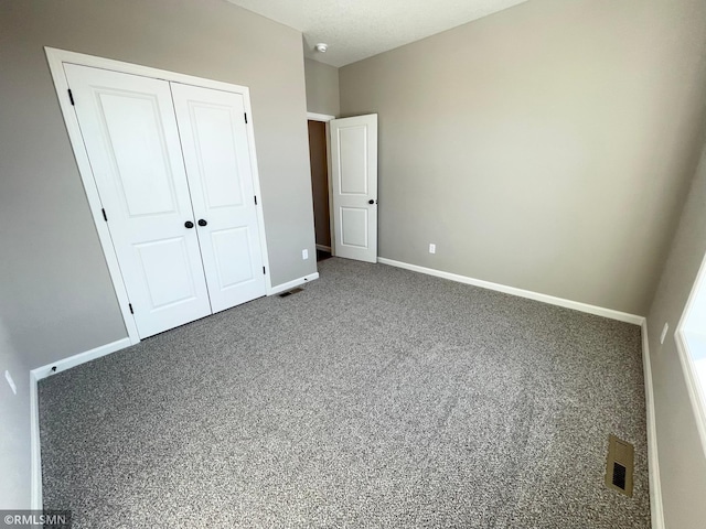 unfurnished bedroom with carpet and a closet