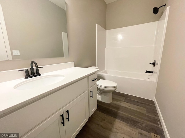 full bathroom featuring shower / bath combination, vanity, hardwood / wood-style flooring, and toilet