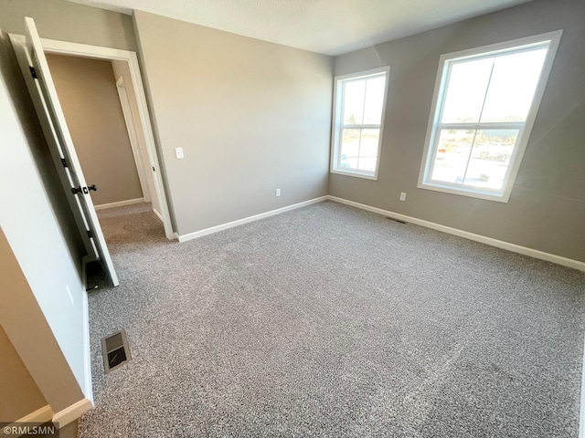 unfurnished room featuring carpet floors