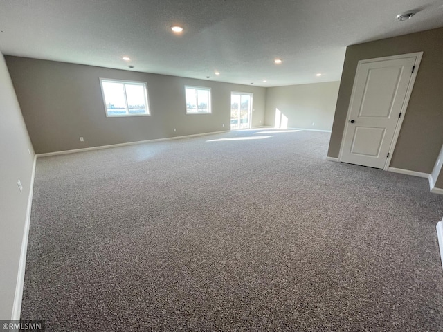 empty room featuring carpet floors and a textured ceiling