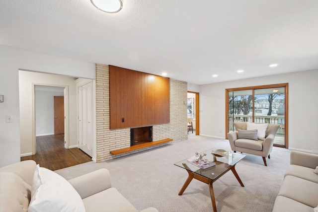 living room with hardwood / wood-style floors and a brick fireplace